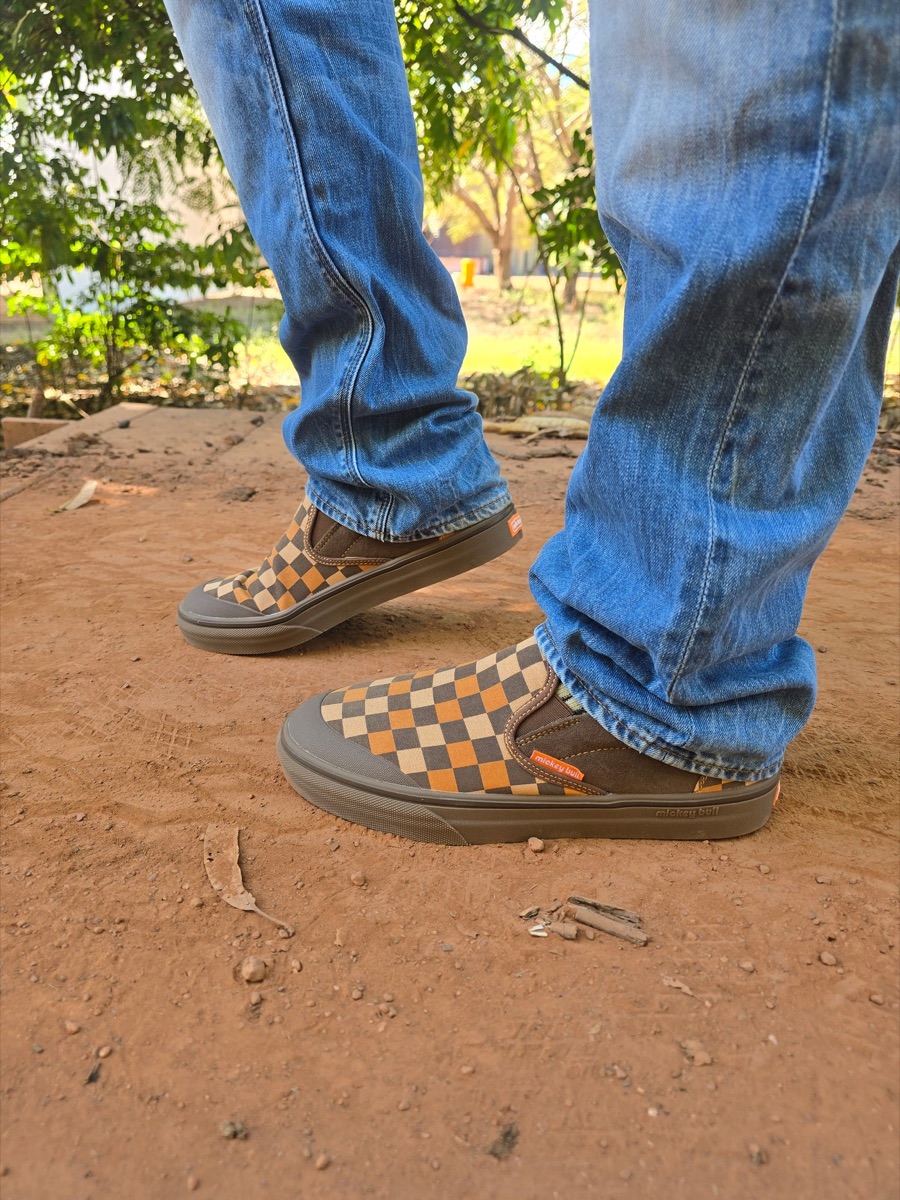 Checkered BuLLShu slip-ons on red dirt